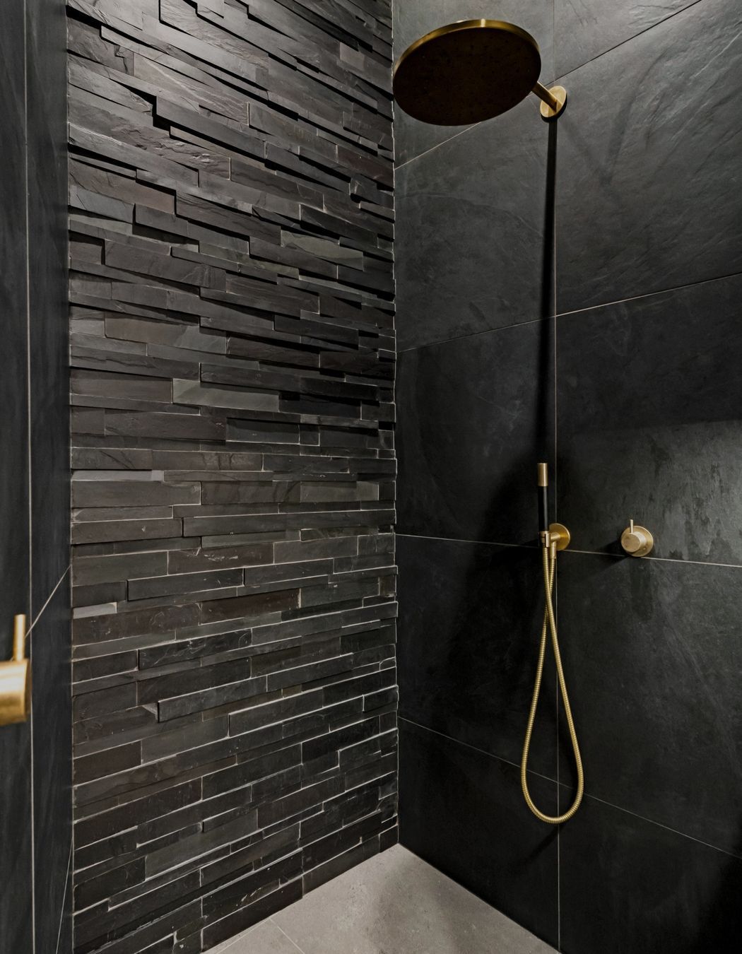 "An exquisite 'Island Stone' feature wall extends dramatically into the unused attic space, achieving an impressive four-meter floor-to-ceiling height. Dimmable recessed ceiling strip lighting enhances the atmosphere, creating a sophisticated and inviting ambiance throughout the area."