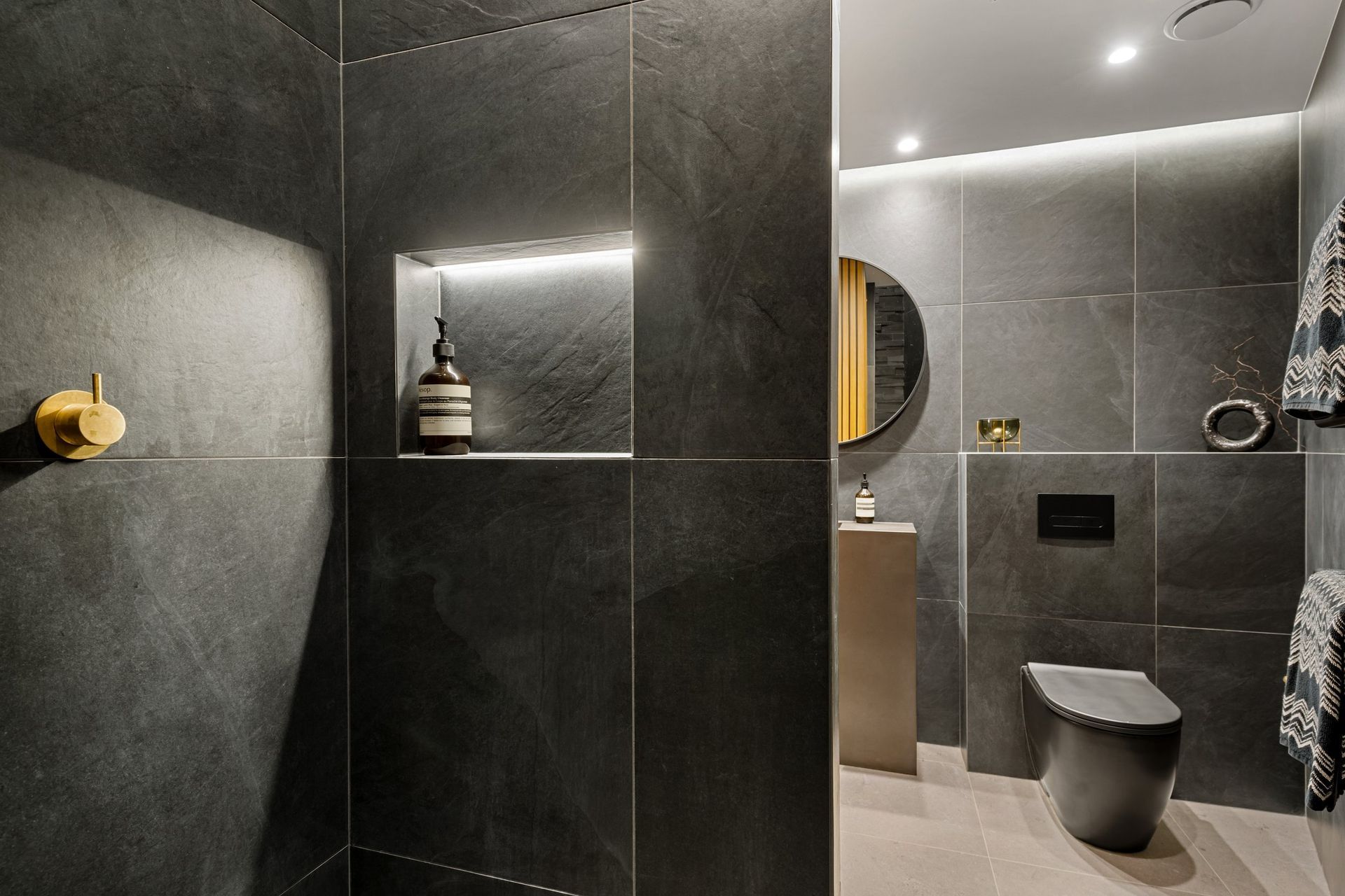Equipped with both motion-sensor and dimmable recessed lighting, this bathroom strikes the perfect balance between moodiness and practicality, enhancing the overall ambiance and functionality.