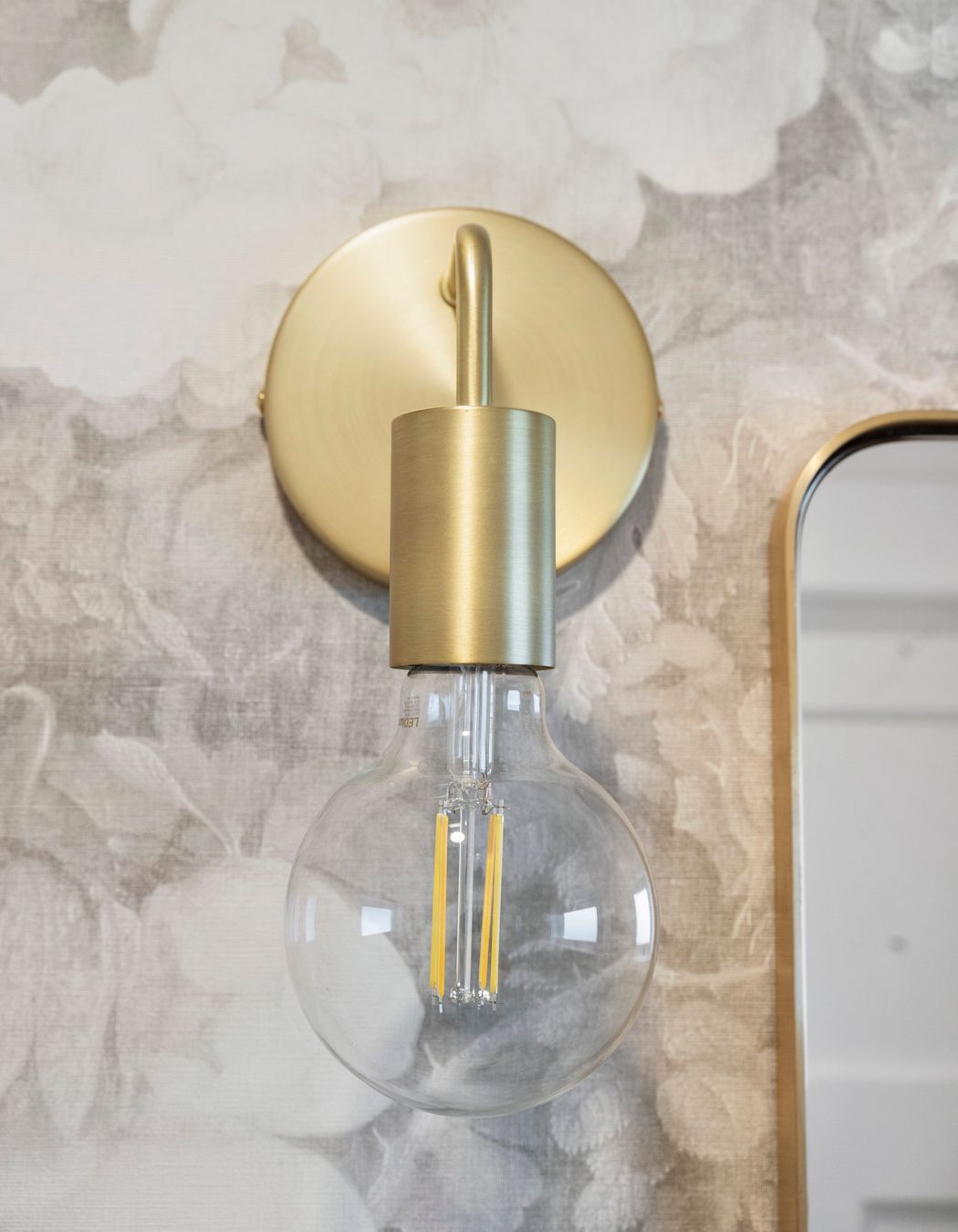 The gentle, curved lines of the brushed brass accents seamlessly blend into the overall design of the space, adding a touch of elegance and sophistication. These soft contours complement the existing elements, creating a harmonious interplay of textures and finishes. The refined brass detailing not only enhances the aesthetic but also invites warmth, making the room feel inviting and beautifully cohesive.