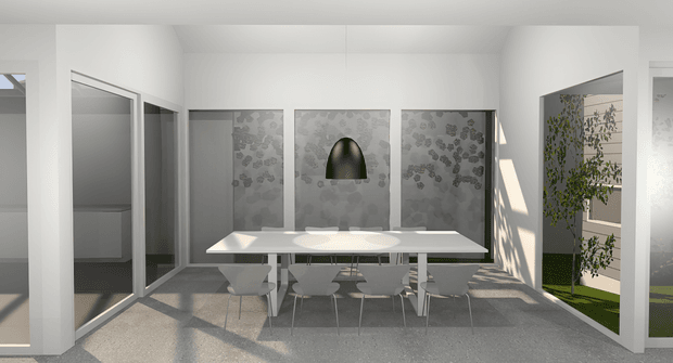 Bright contemporary dining area with a long white rectangular dining table and several light grey upholstered chairs. The room has white walls and ceiling, large glazed openings, a textured grey floor, and a feature wall composed of grey patterned panels with a central dark arched niche or artwork. Strong sunlight enters from the right, casting shadows and revealing greenery in an adjacent courtyard or outdoor area.