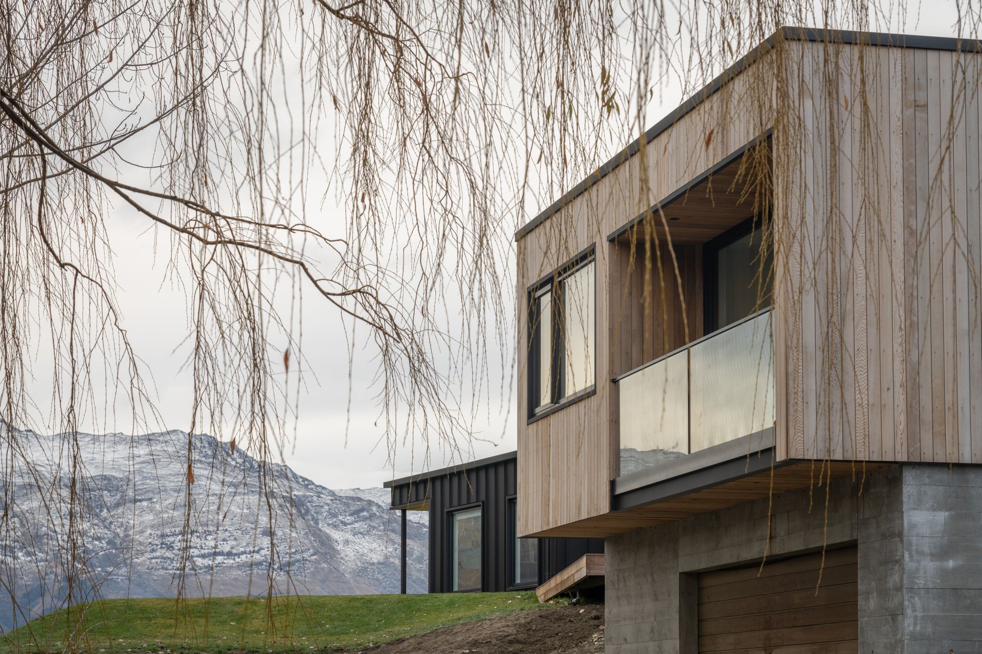 Metal tray cladding contrasts with the earthier, natural tones of cedar and board-finished concrete