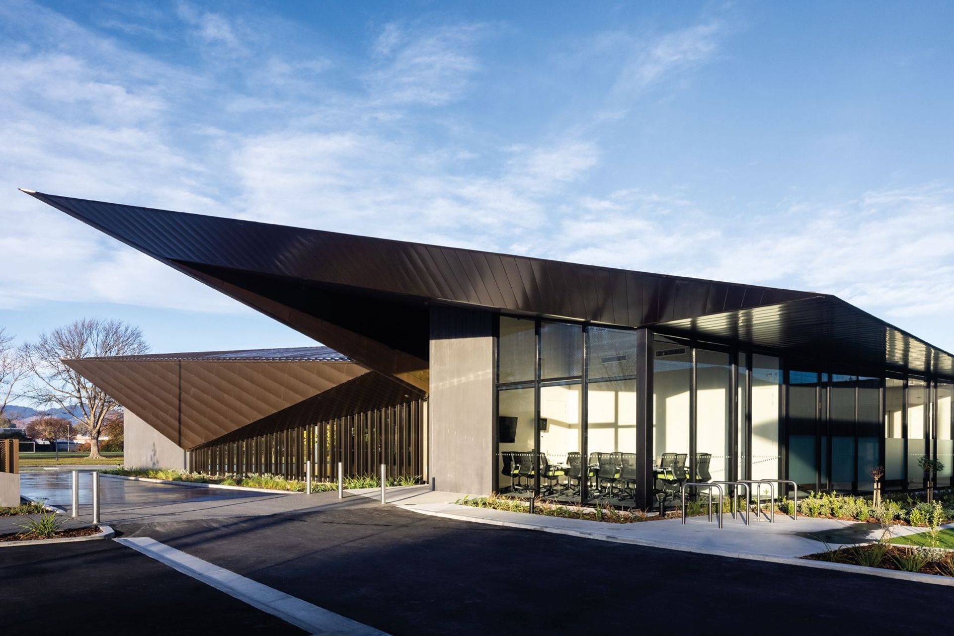 Large areas of glazing and aluminium and counterbalanced by precast elements, which serve to visually anchor the structure to the site. Photography by Clinton Lloyd.
