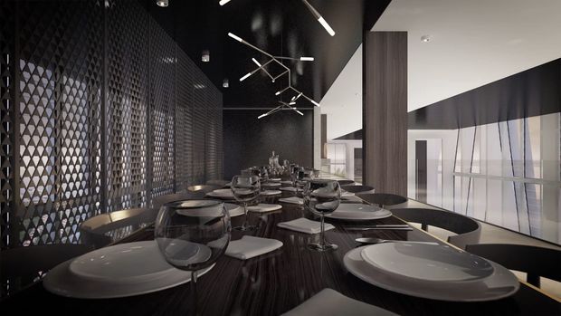 A sophisticated contemporary dining room with a long dark wood dining table set for a large group. The space features dark tones, sculptural linear pendant lighting, a dramatic black ceiling, a patterned perforated screen wall, and floor-to-ceiling glazing with sheer curtains. A vertical dark timber-clad column separates the dining area from the bright glazed edge, creating a refined, high-contrast atmosphere.