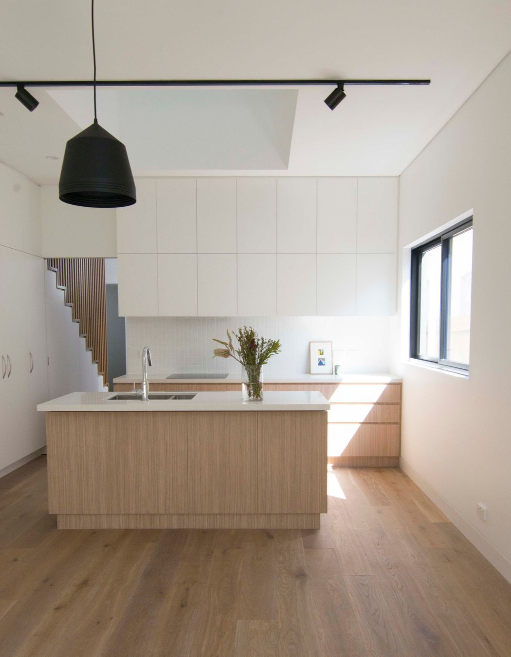 A soft and raw material palette for the kitchen. A consideration for natural light and view points as a void over connects the two levels.