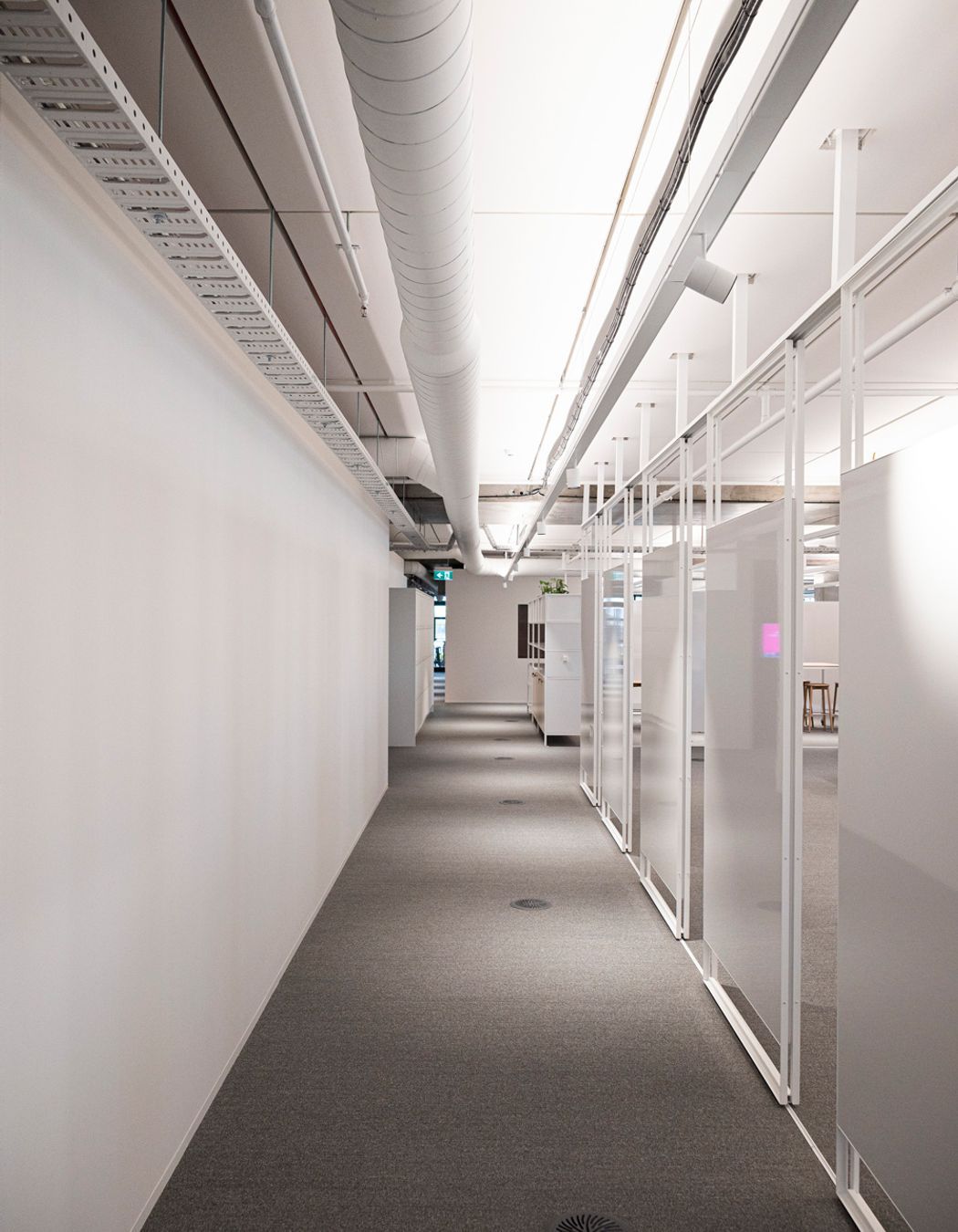 A sliding track allows these whiteboards to move and transform spaces. Studco engineering ensured that open plan spaces such as this office floor were feasible.