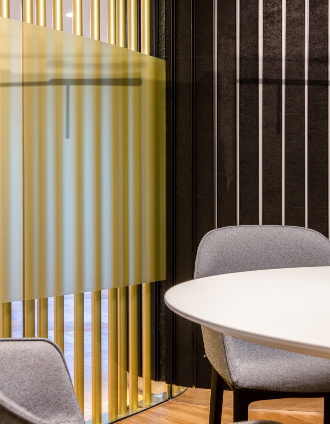 Detail - brass pole screen and acoustic dark wall