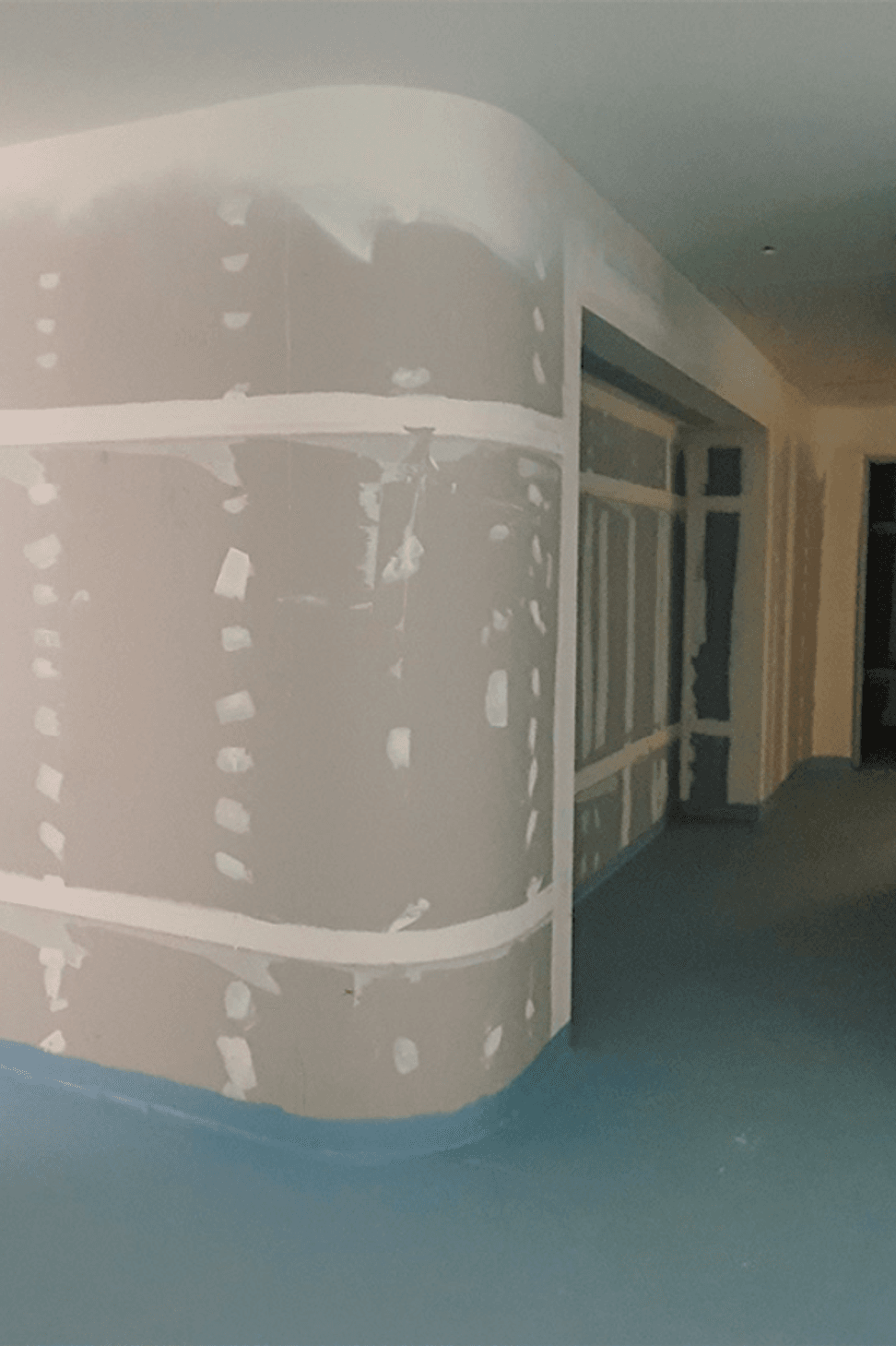 Studco EzyTrack used to create curved walls which include storage spaces. The finished curved walls provide function and aesthetic, adding to the flowing curves of Wesley Place.