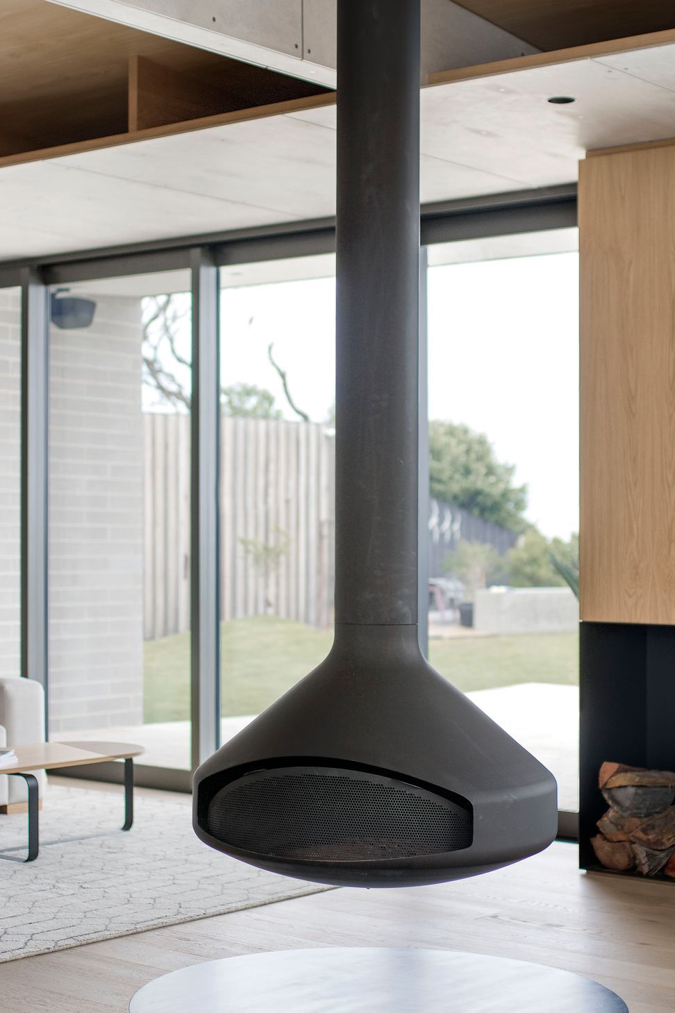 The Oblica suspended fireplace swivels 360 degrees, earning its focal position between the dining and living spaces