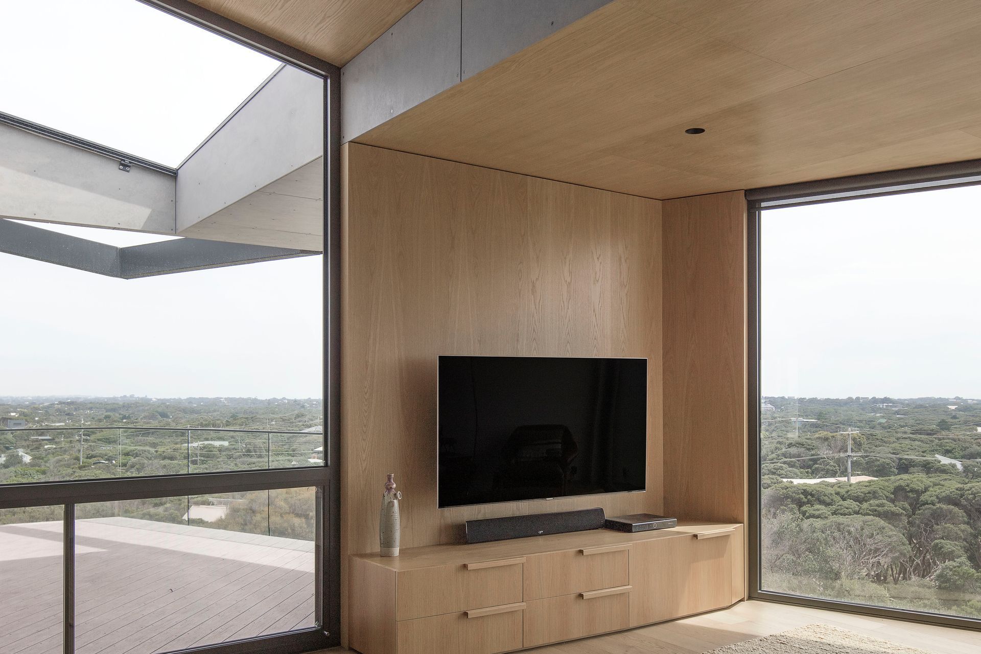 The beach house retreat provides lofty coastal views across an elevated timber deck