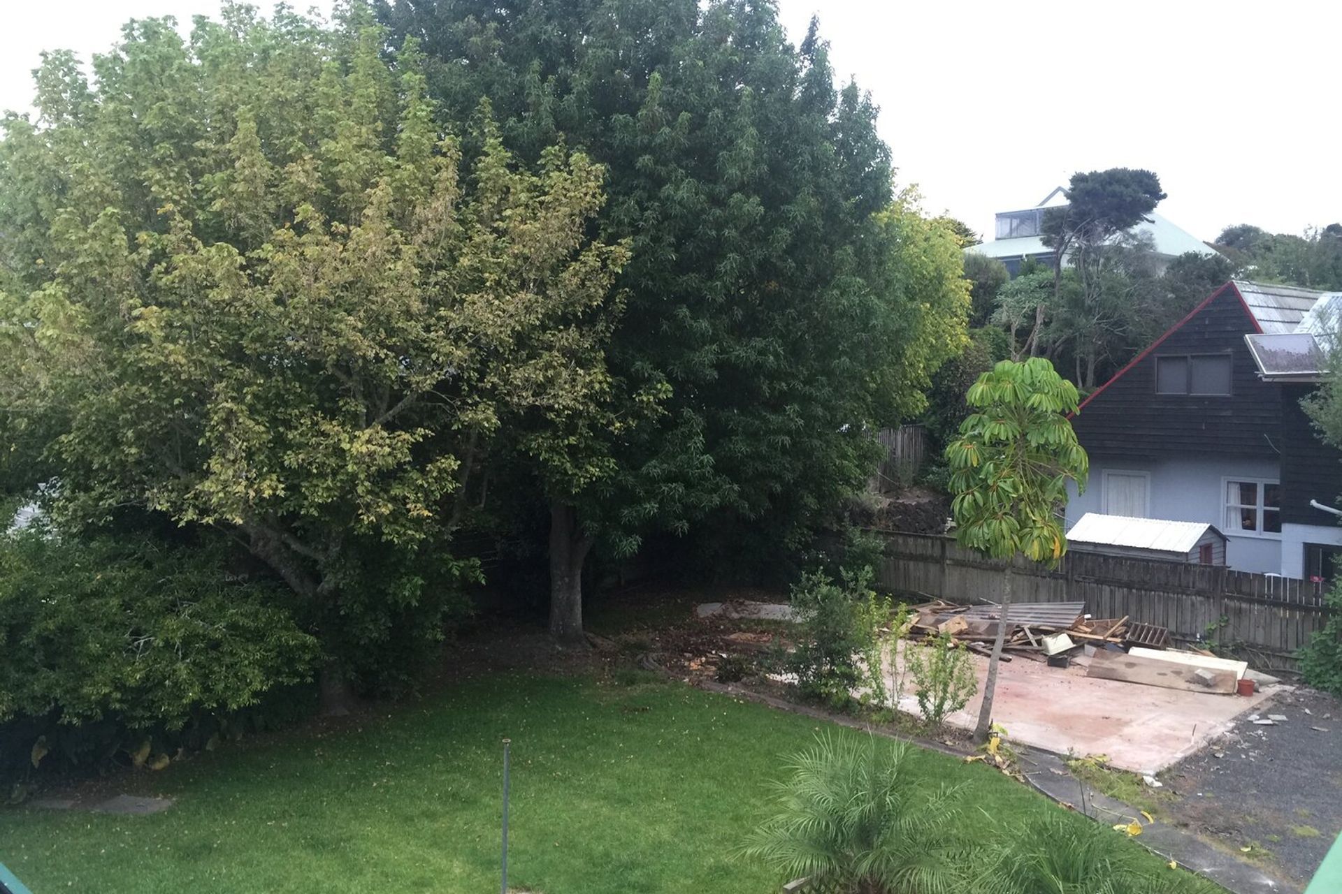 The existing garage was transported from site to a new location, and the trees were removed to make space for the new house.