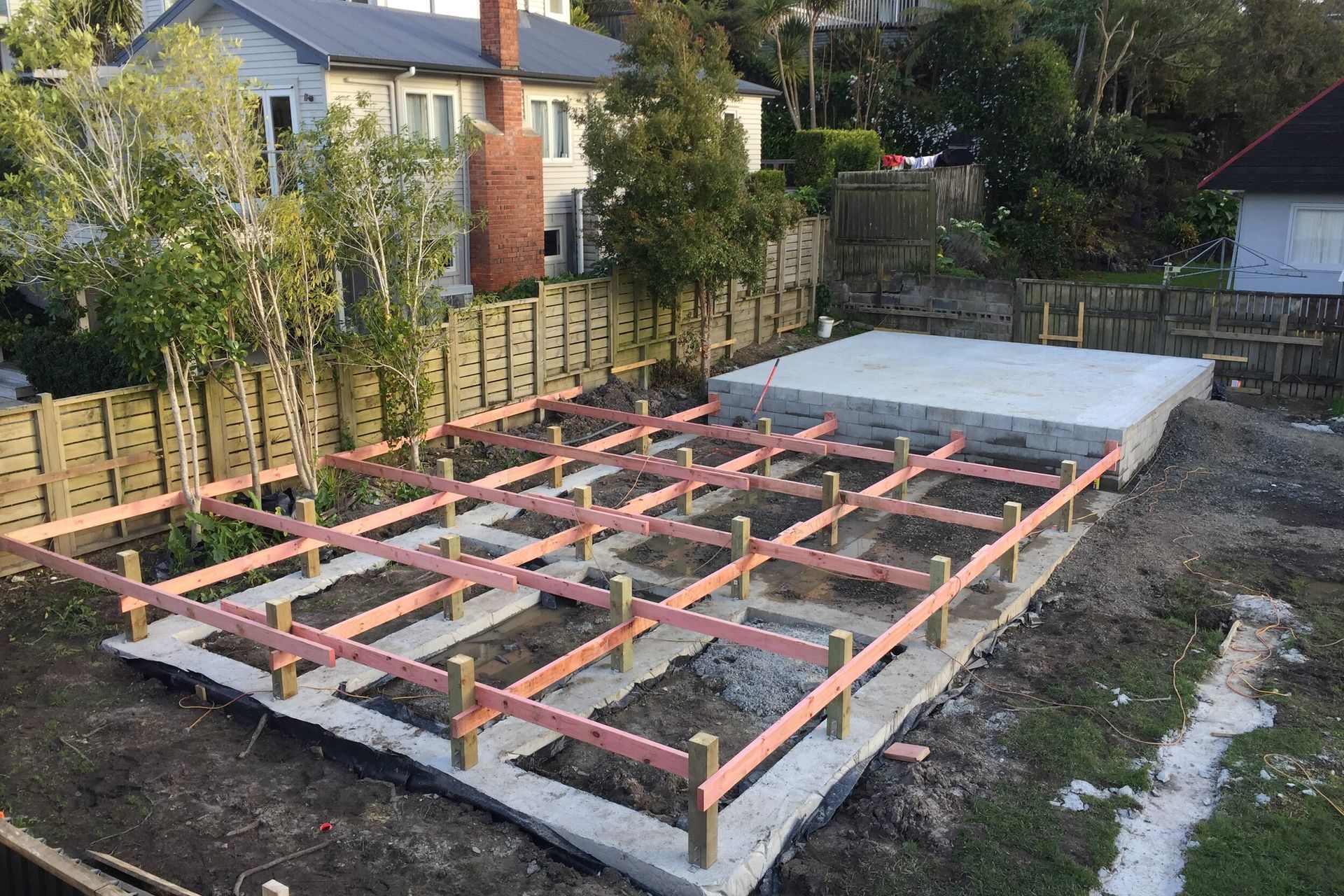 Concrete poured for the floating piles, and initial flooring framework going up.
