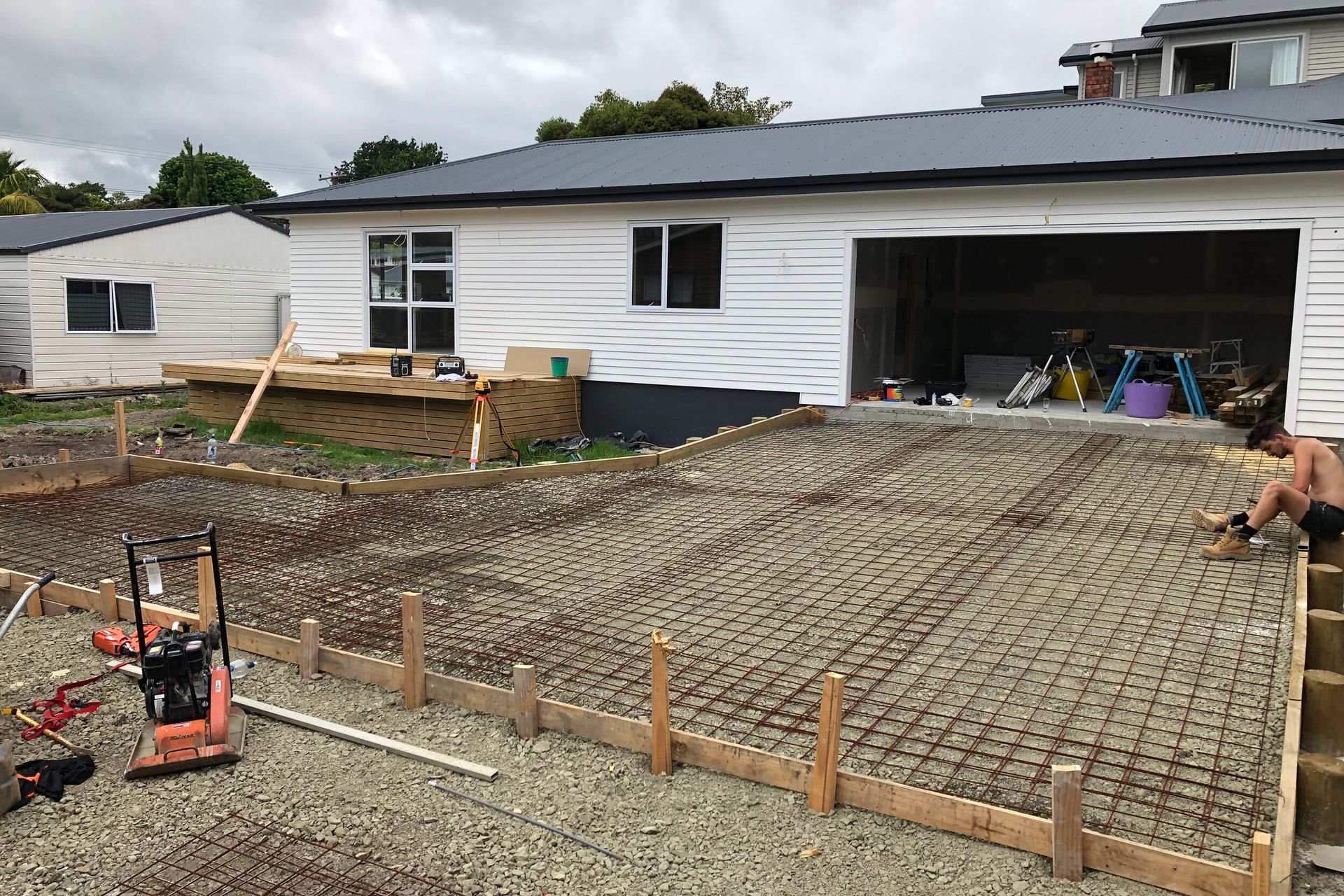The house exterior nearly complete, the pourers concrete driveway being prepared