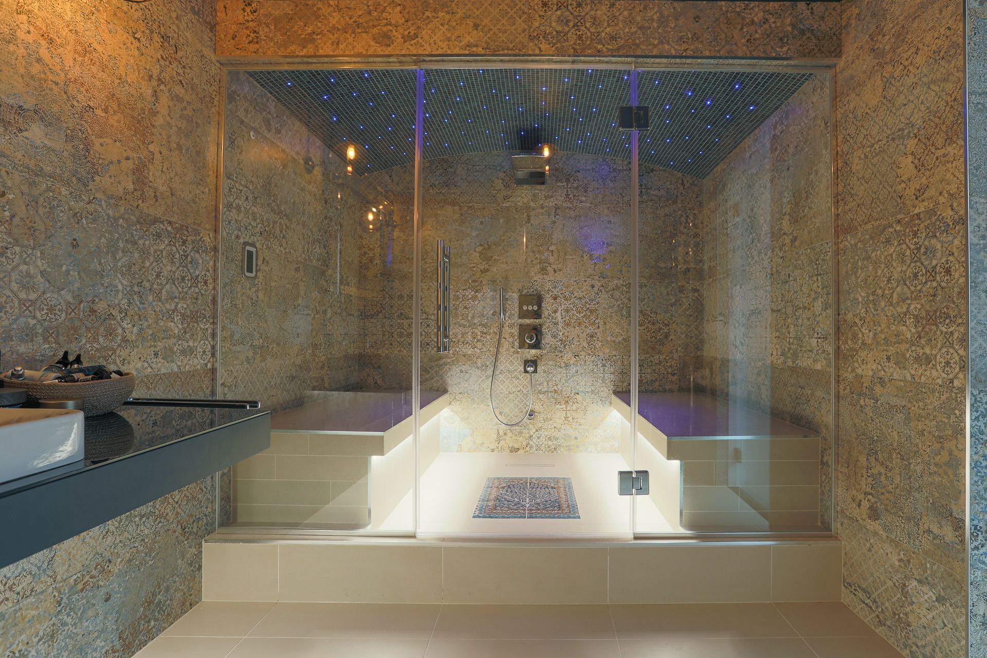 The Sauna room was pure wellbeing and regeneration with the tree of life tile being the starting point for the design, and adding tiles in a time honoured carpet pattern.