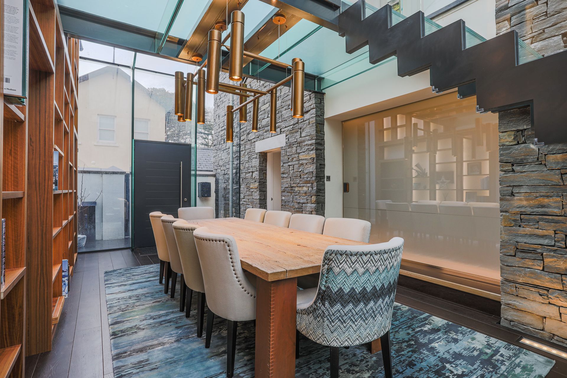 A Sliding Door in Switch Glass leads into the open plan kitchen, dining, and living area. The switch glass can change from opaque to clear.