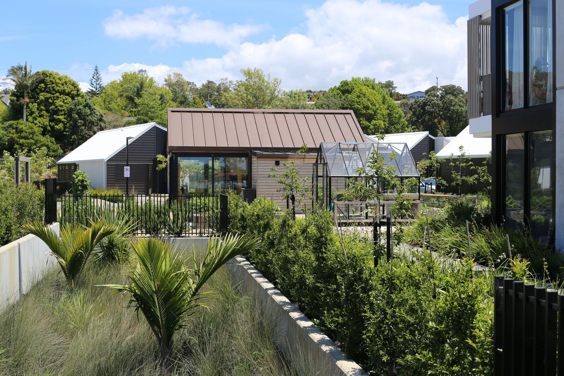 Planting incorporates a mix of natives and exotics to provide year-round interest.  Satin black, low-profile fencing has been used sparingly to ensure safety but without impacting sightlines.