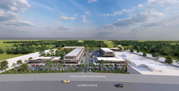 Aerial architectural rendering of a large contemporary commercial development arranged along a major road. Multiple low-rise buildings with flat roofs, landscaped courtyards, parking areas, internal driveways, and a central access street are shown, with a broad rural or suburban landscape extending behind the site. Road labels identify the future Elizabeth Drive upgrade and Elizabeth Drive.