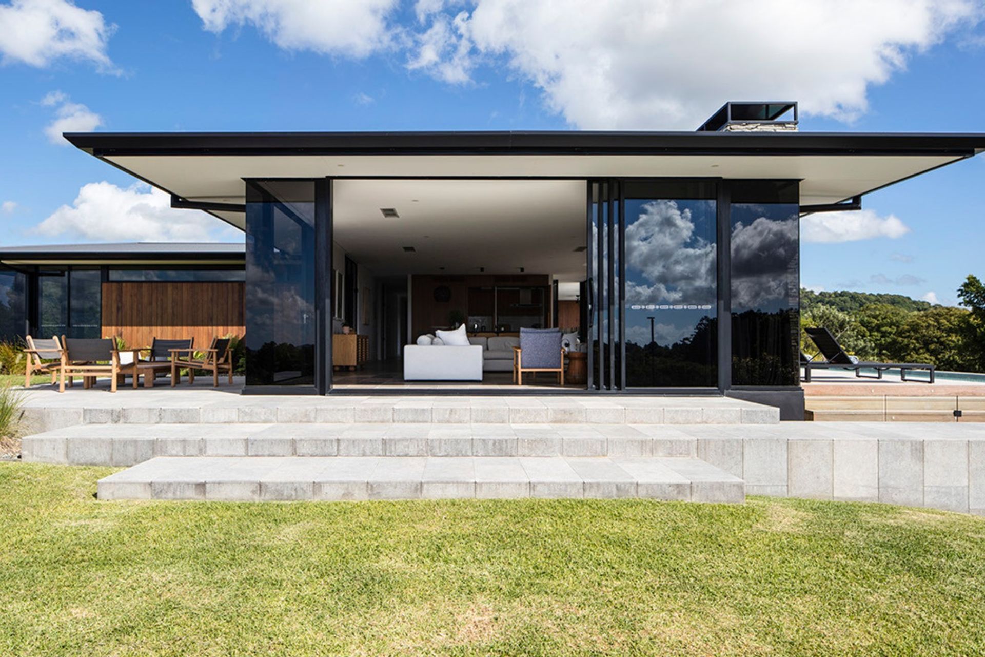 Clark Residence - Exterior. Fine roof edge sheltering full height glazing.