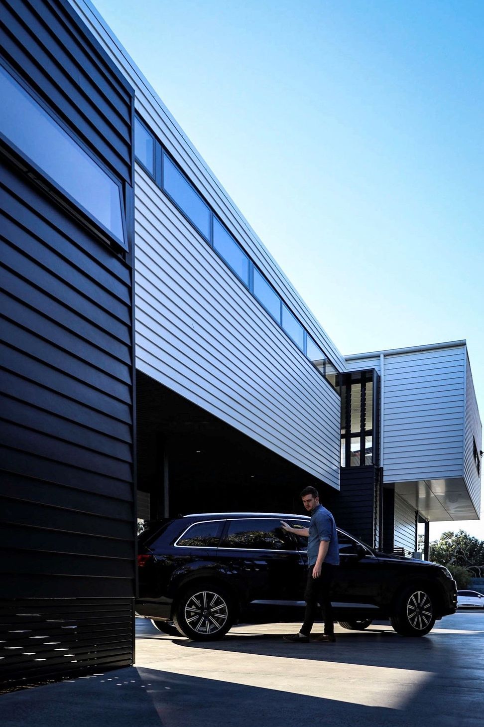 Kruger Residence - Exterior. Dark and light cladding meeting on the side elevation.