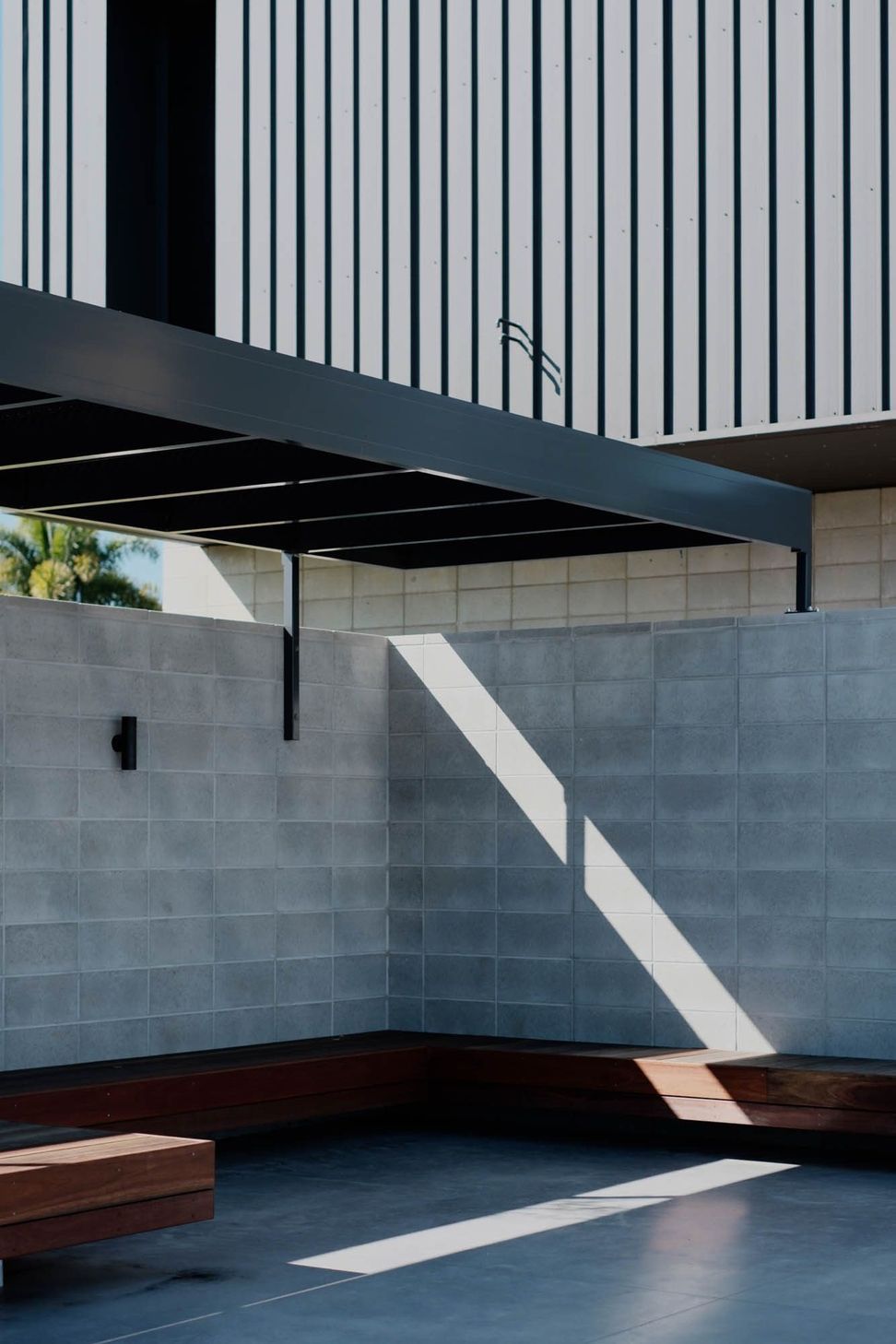 Seabrook and Borg Residence - Patio. Pergola shadows across the block wall.