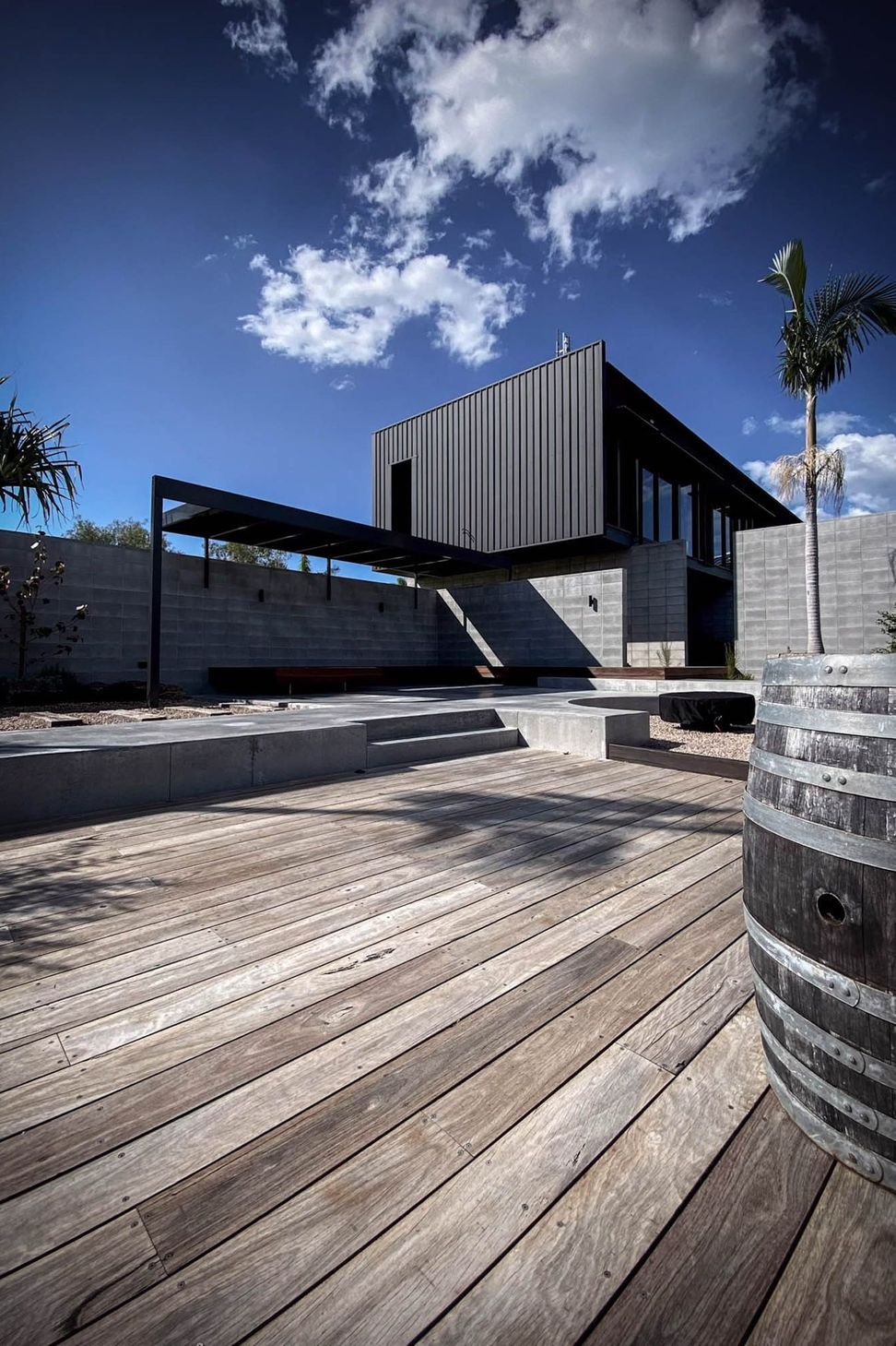 Seabrook and Borg Residence - Patio. Timber deck and curved planter beside the terrace.
