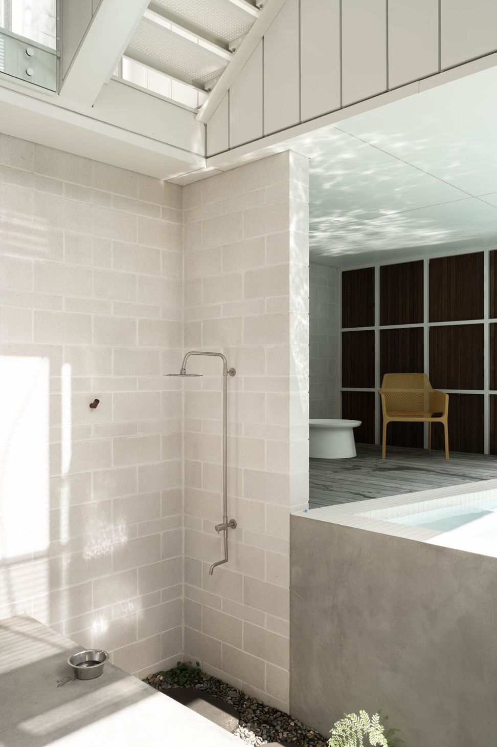 Eleutheria - Bathroom. Open shower with a garden outlook through timber framed glazing.