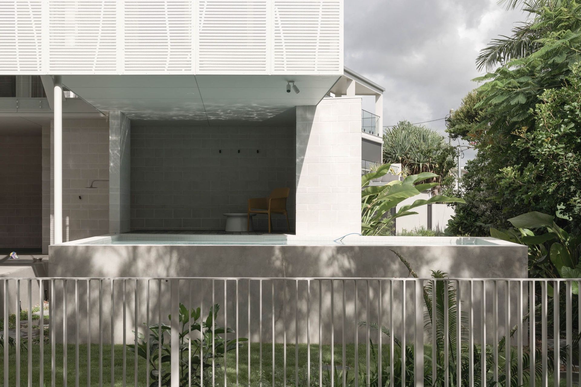 Eleutheria - Exterior. Screened upper level over the pool fence and garden.