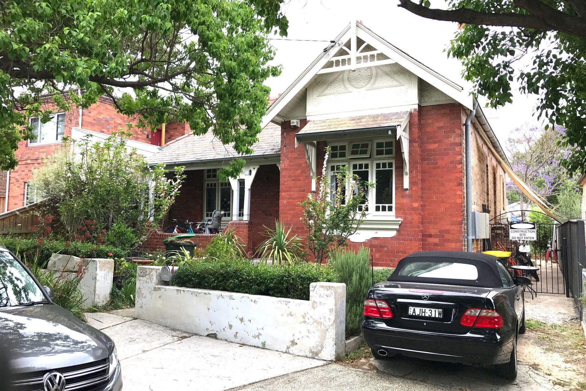 Before the work commenced. Shade sails down the side driveway to mitigate western sun heating up brick cottage