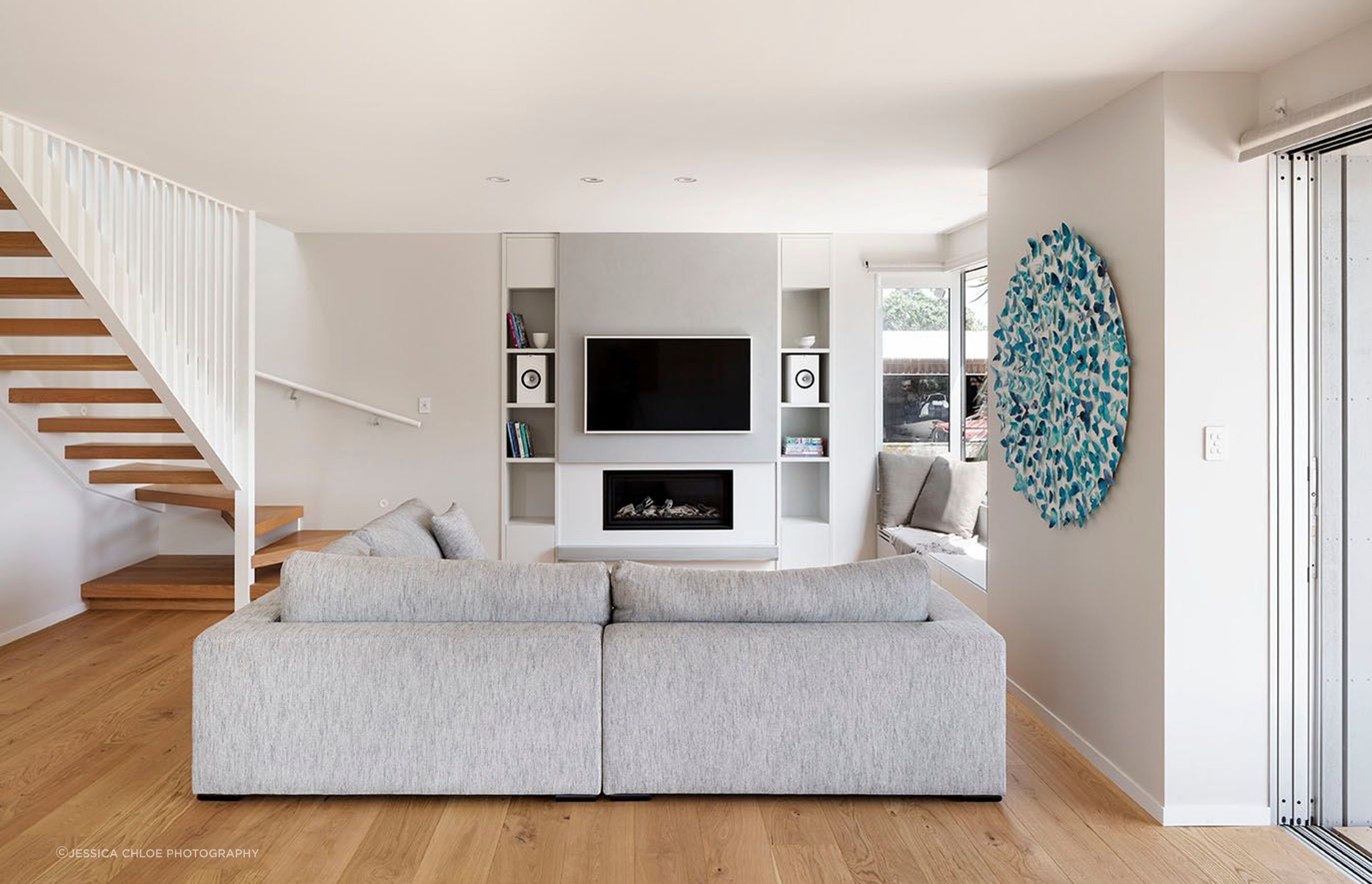 Clean lines in the living room, floating stairs and lines of the railing add a dynamic touch