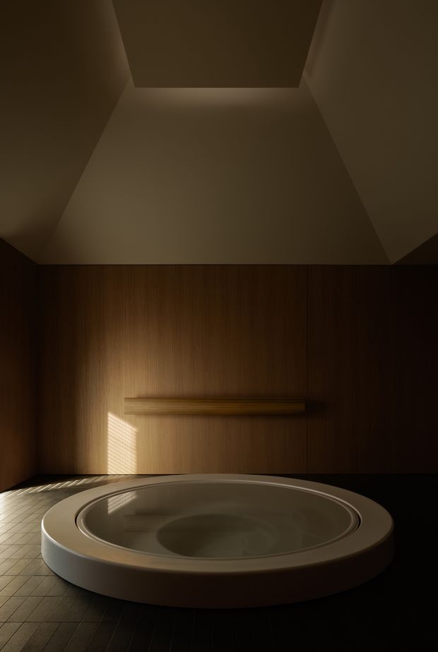 A dark, atmospheric bathroom featuring a large circular freestanding soaking tub in the foreground. The room has warm vertical timber wall panelling, a tiled floor, a minimal horizontal wall-mounted fixture or shelf, and dramatic concealed ceiling lighting with sunlight filtered through blinds.