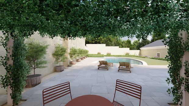 A secluded courtyard terrace framed by dense climbing greenery, with pale stone paving, potted trees, lounge chairs, and a curved swimming pool beyond. The space has a refined garden-courtyard setting and a calm, resort-like atmosphere.