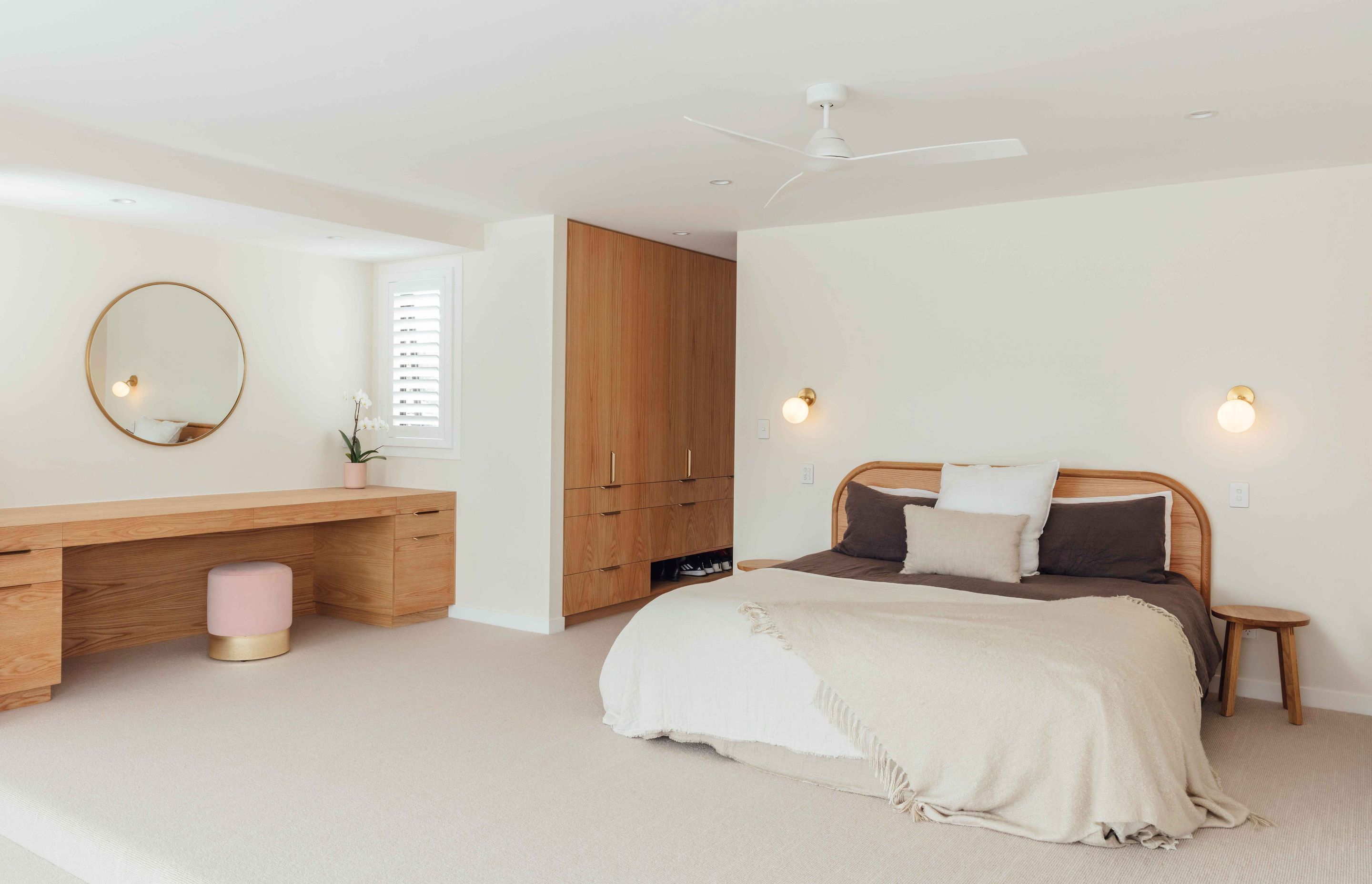 The main bedroom is a study in refined elegance with a muted colour palette teamed with timber and brass accents.