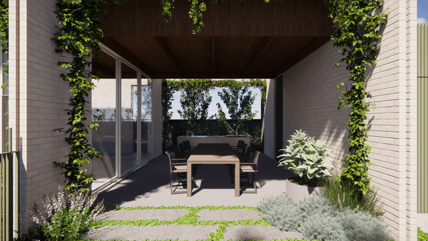 A covered outdoor courtyard or terrace framed by pale brick walls and climbing greenery. The space features a timber-lined ceiling, extensive glass sliding doors, a central outdoor dining table with chairs, built-in or paved flooring, and landscaped planting around the perimeter. The setting feels private, calm, and contemporary, with a strong indoor-outdoor connection.