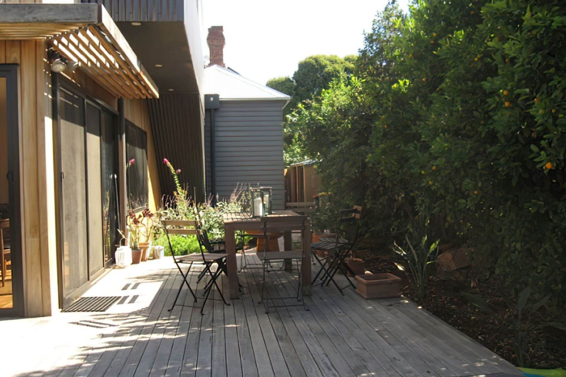 AFTER the garden design. A new decking area amid a secluded garden