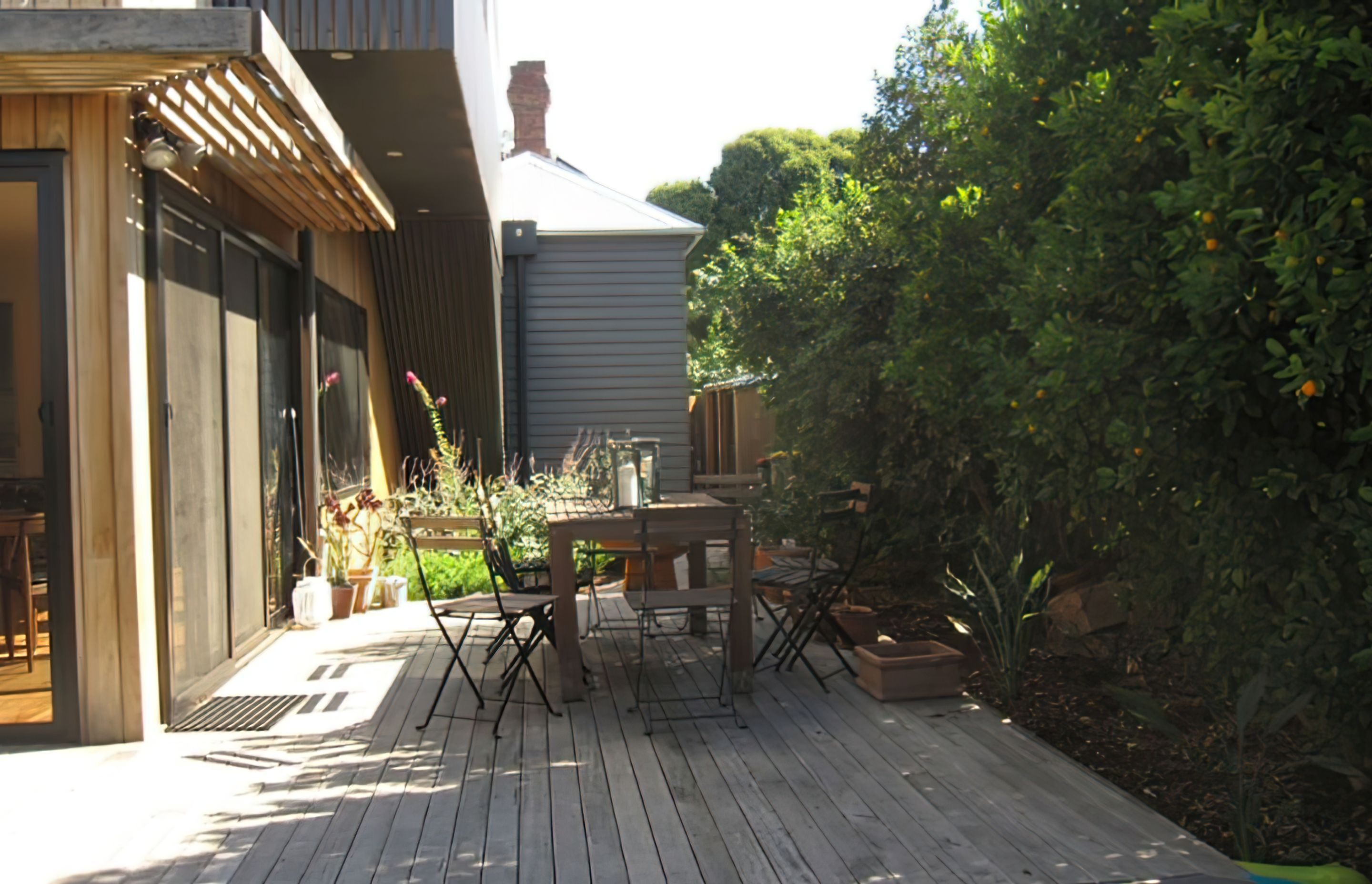 AFTER the garden design. A new decking area amid a secluded garden