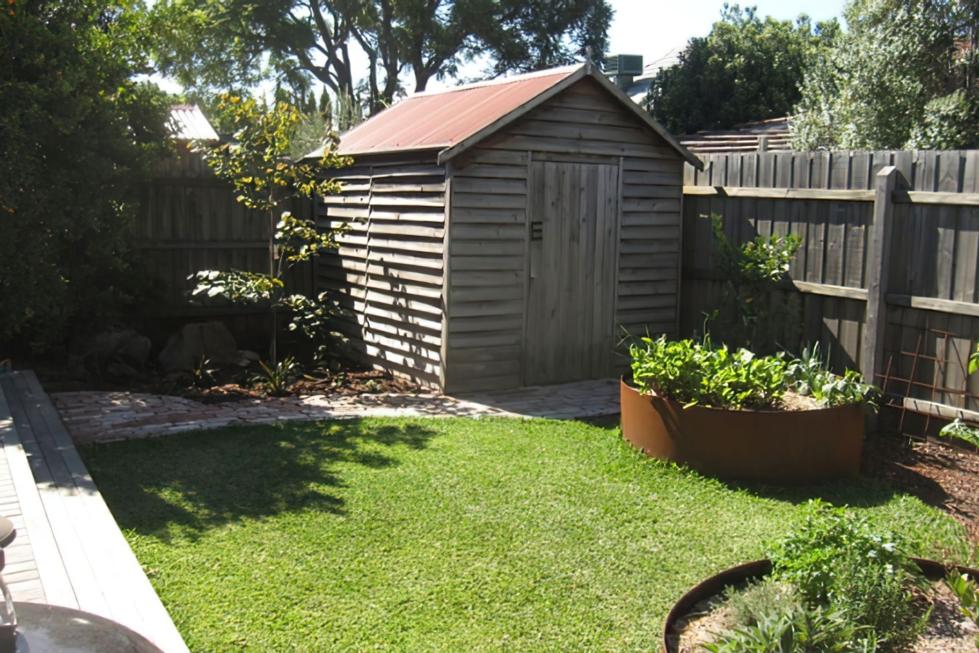 AFTER the garden design. A small shapely lawn now connects the decking with the veggie zone
