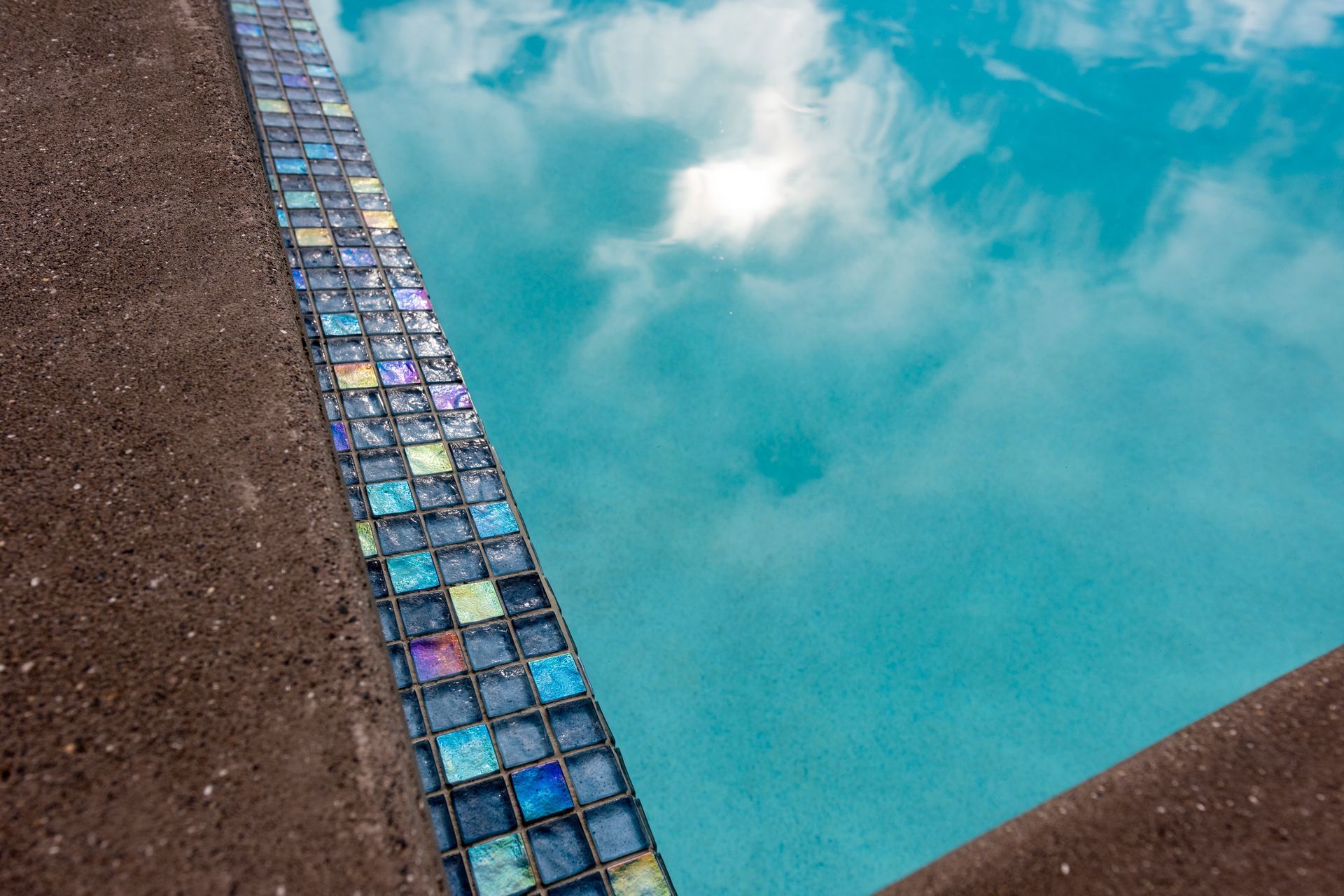 The Palmer &amp; Allen Tiles used for the pool waterline and horizon edge can look very different across the space of the day, depending on how the sunlight captures them