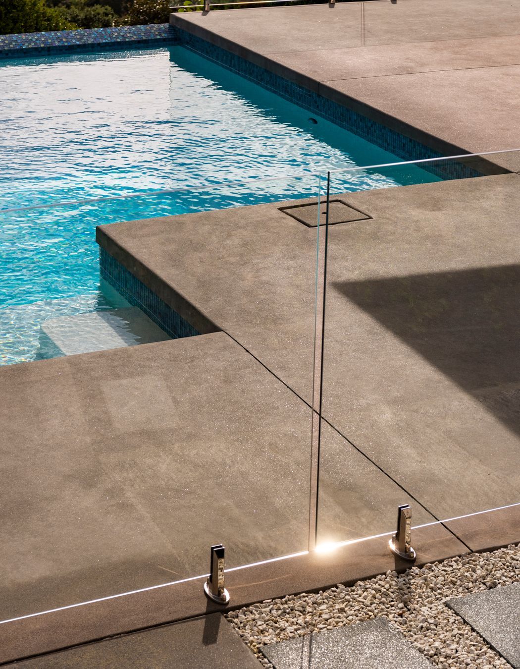 The homeowner opted for a poured concrete finish right to the pool edge