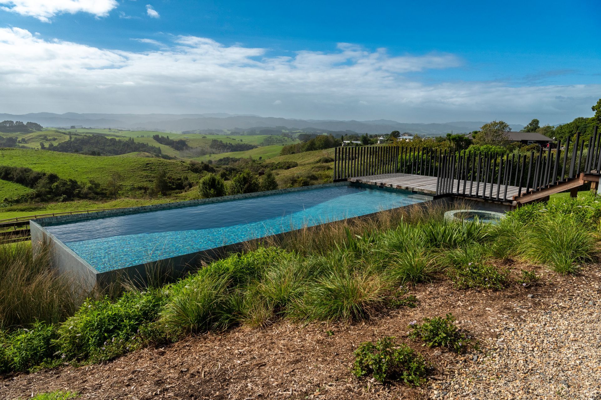 Native plantings taking hold, the spa being particularly private, nestled in amongst the garden bed.