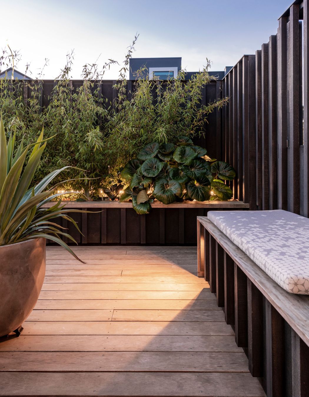 Subtle lighting integrated into the furniture and timber screens adds atmosphere
