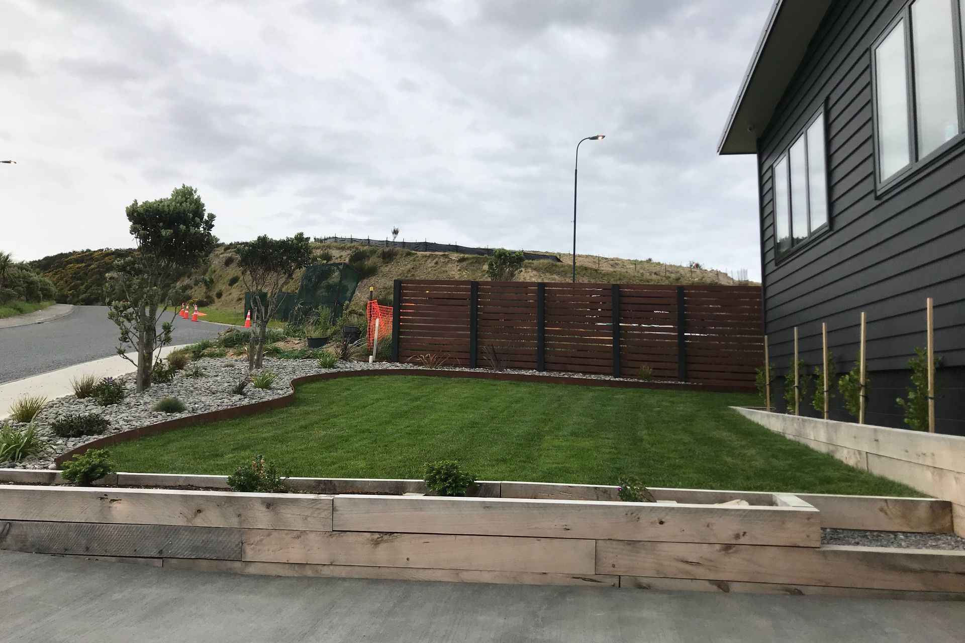 A rich patina finish of the weathering steel compliments the lush green grass of the section.