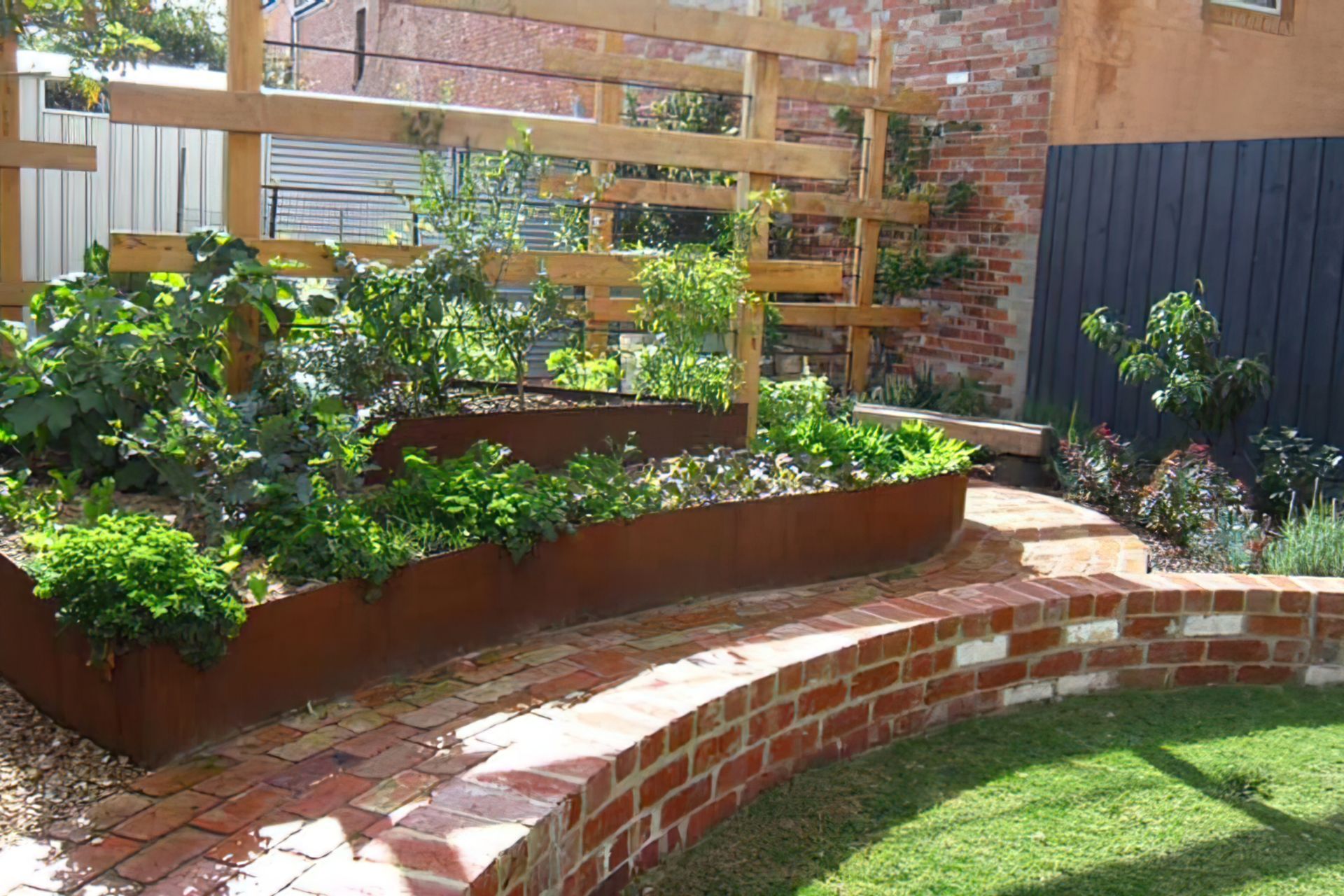 Old brick 'sitting wall' around a sunken lawn - AFTER design