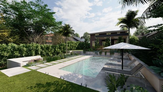 A landscaped backyard with a rectangular swimming pool, pale paved pool surround, white built-in bench seating, large white umbrella, and lush tropical planting. A contemporary flat-roofed house and covered outdoor area are visible beyond the pool.
