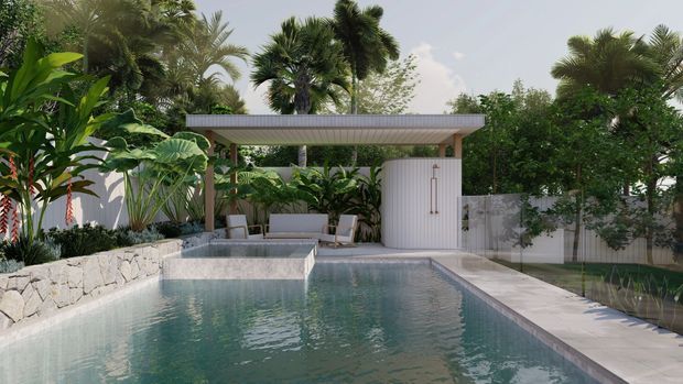 A lush tropical outdoor pool courtyard with a rectangular swimming pool, raised stone-edged planter, covered poolside pavilion, outdoor seating, and a curved white ribbed enclosure. Dense palms and broad-leaf planting surround the space, creating a private resort-like setting.