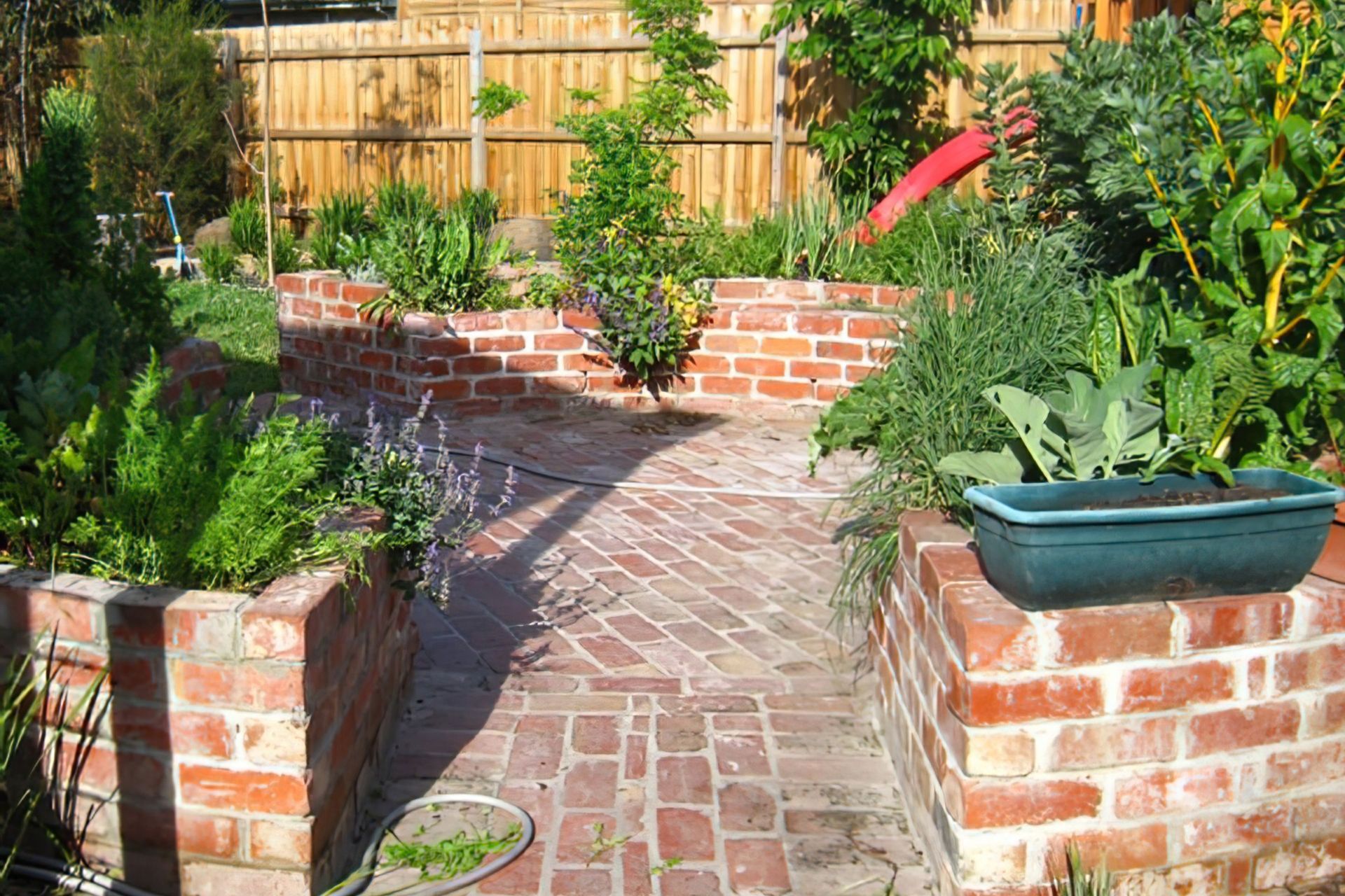 Northcote backyard AFTER garden design, featuring raised brick vegetable planters