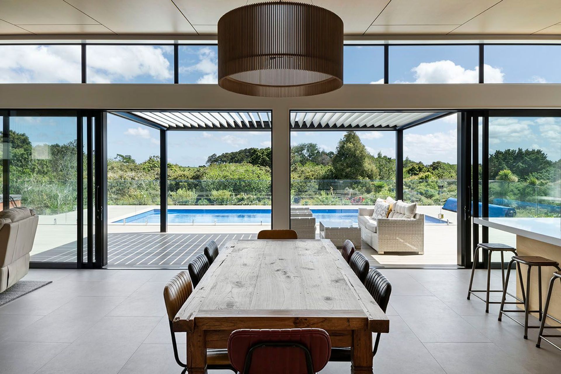 Living areas seamlessly connect to the decks and pool.