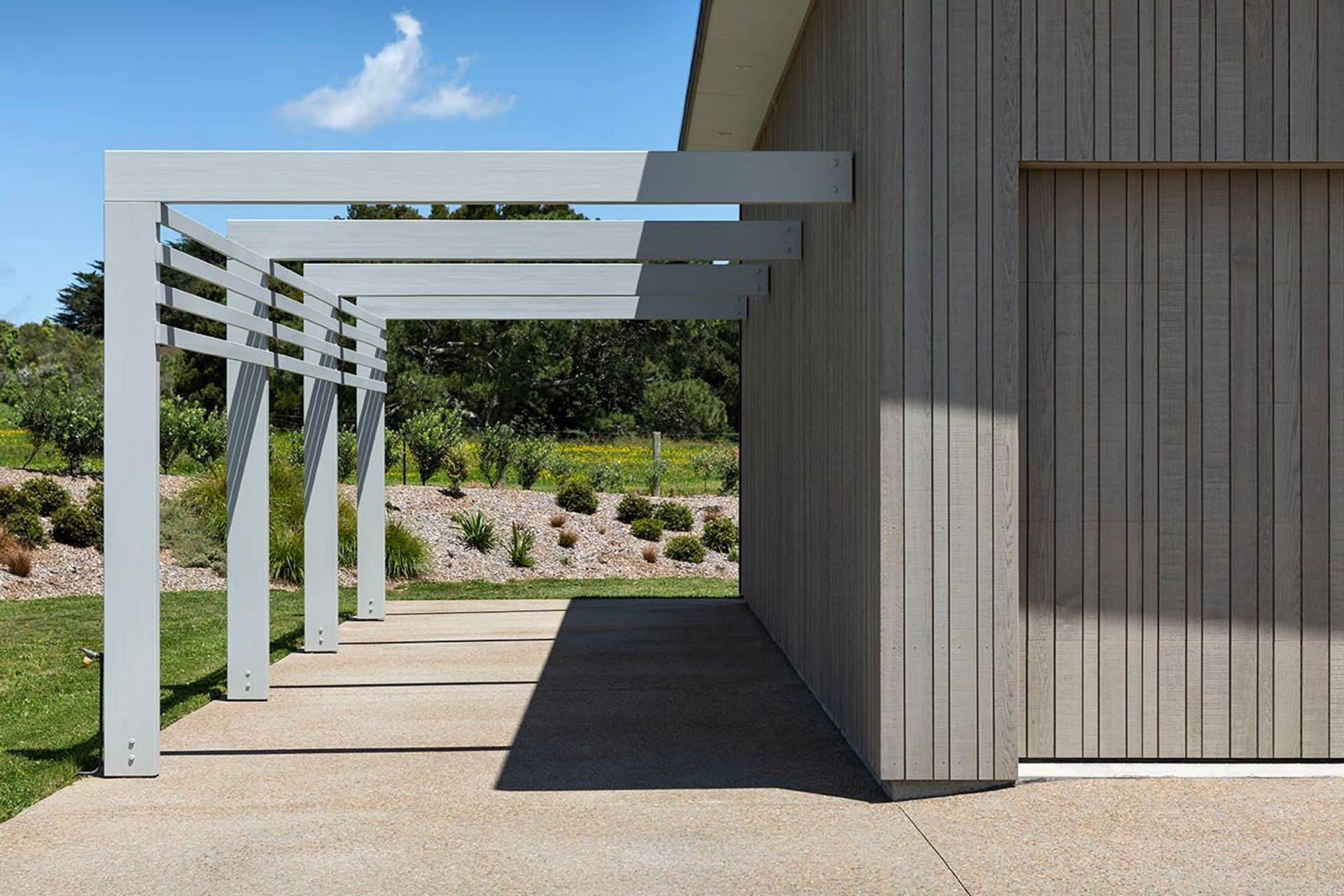 An invisible garage door when clad with the same blonded exterior cedar cladding as the rest of the home..