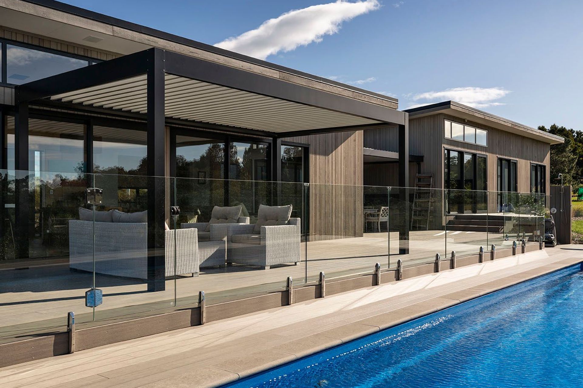 Generous composite decks lead out to the pool from the outdoor entertaining area.