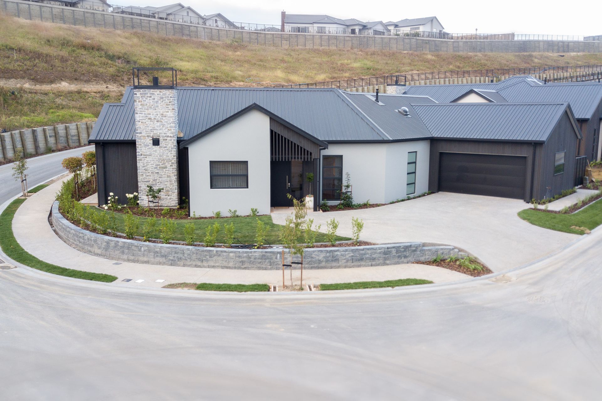 Dark colours combine with textural elements on the exterior.