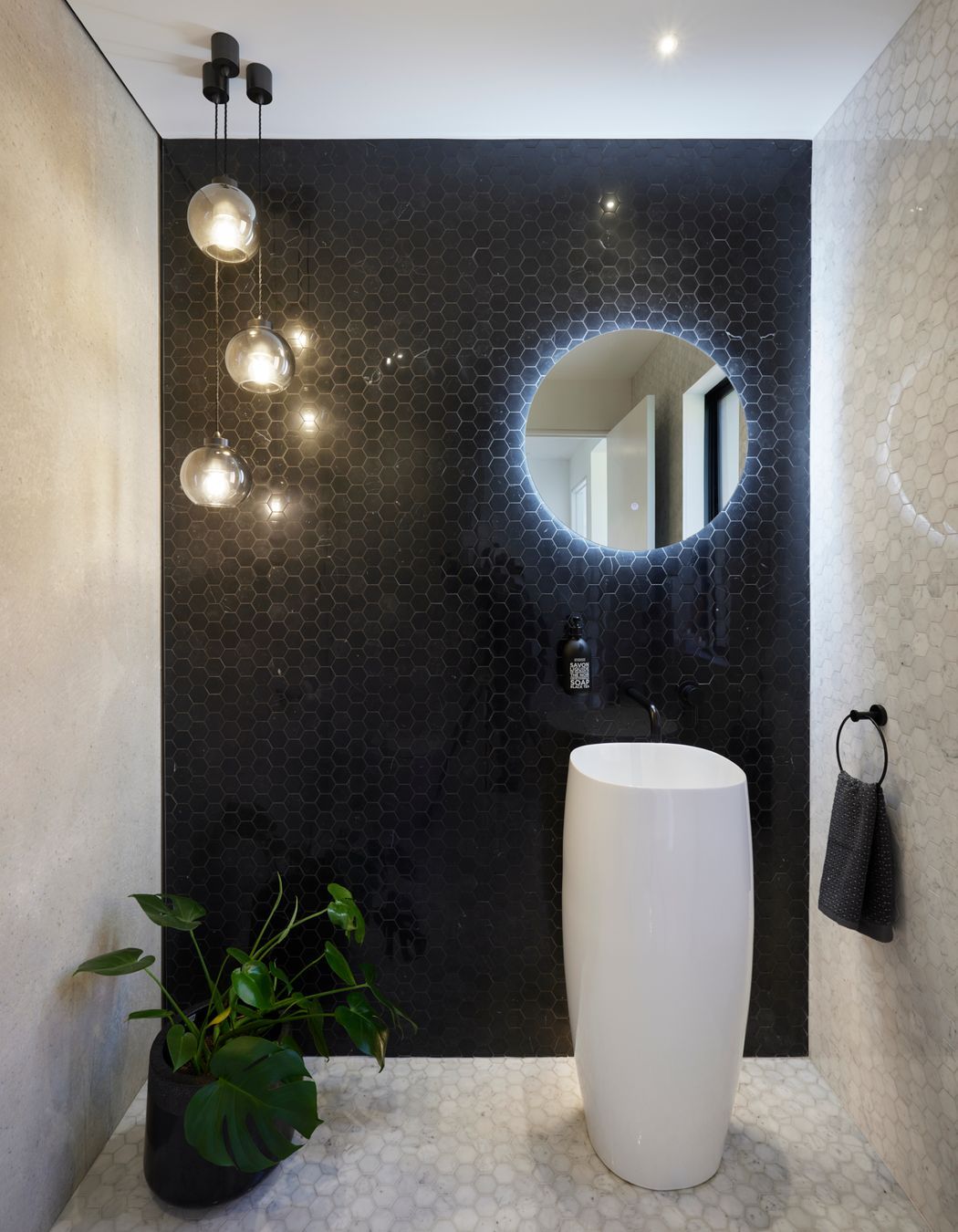 The bathrooms maintain a monochrome palette.
