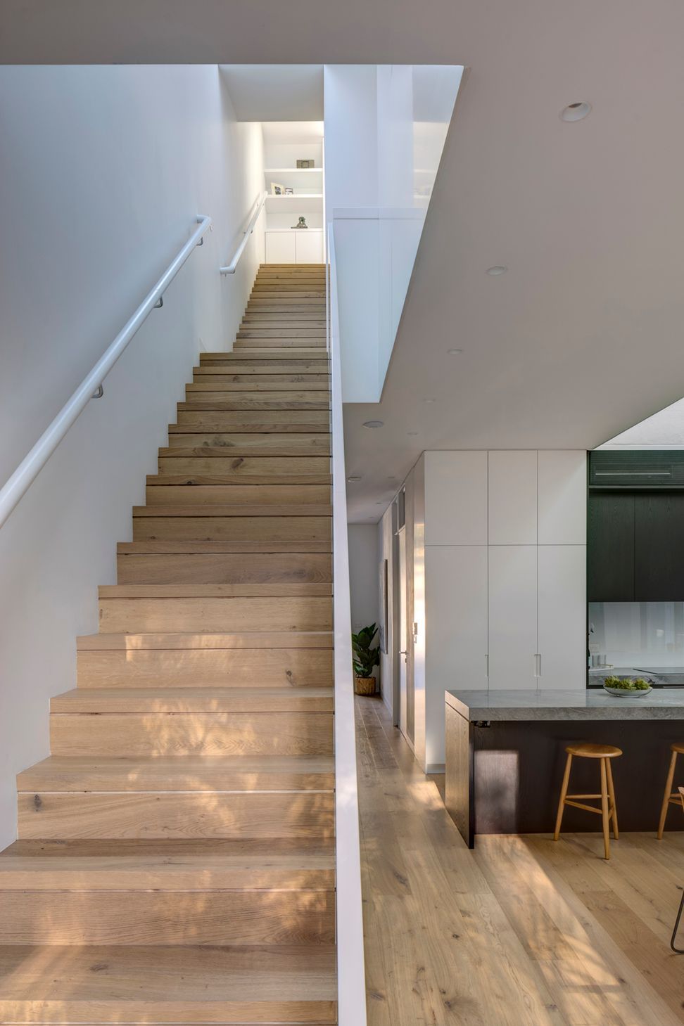 The stairs are arranged in sequence, creating expansive space within a compact footprint.